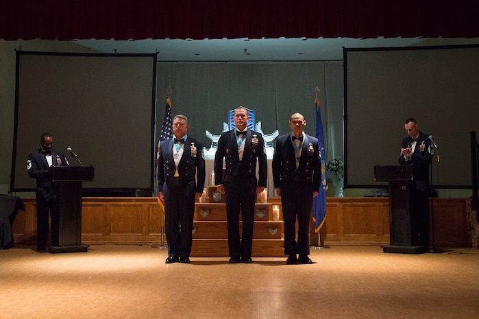 (From left to right)Chief Master Sergeant Gwen Crabtree, 38th Aerial Port Squadron superintendent, Chief Master Sgt. Chad Neubarth, 16th Airlift Squadron superintendent and Chief Master Sergeant Bryan Whitley, 437th Aerial Port Squadron superintendent stand at attention during a Chief's Recognition Ceremony March 5, 2016, at the Red Bank Club on Joint Base Charleston - Weapons Station. JB Charleston recognized three new chief master sergeants from the recent promotion cycle during the ceremony. (U.S. Air Force photo/ Staff Sgt. George Goslin)