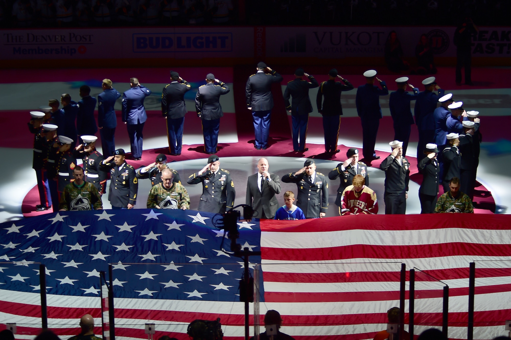Military members from all branches gathered at center ice for the national anthem March 5, 2016, at the Pepsi Center in Denver, Colo. The Colorado Avalanche held the fifth annual “Military Appreciation Day” to honor military members for their service to the United States. (U.S. Air Force photo by Airman 1st Class Luke W. Nowakowski/Released)