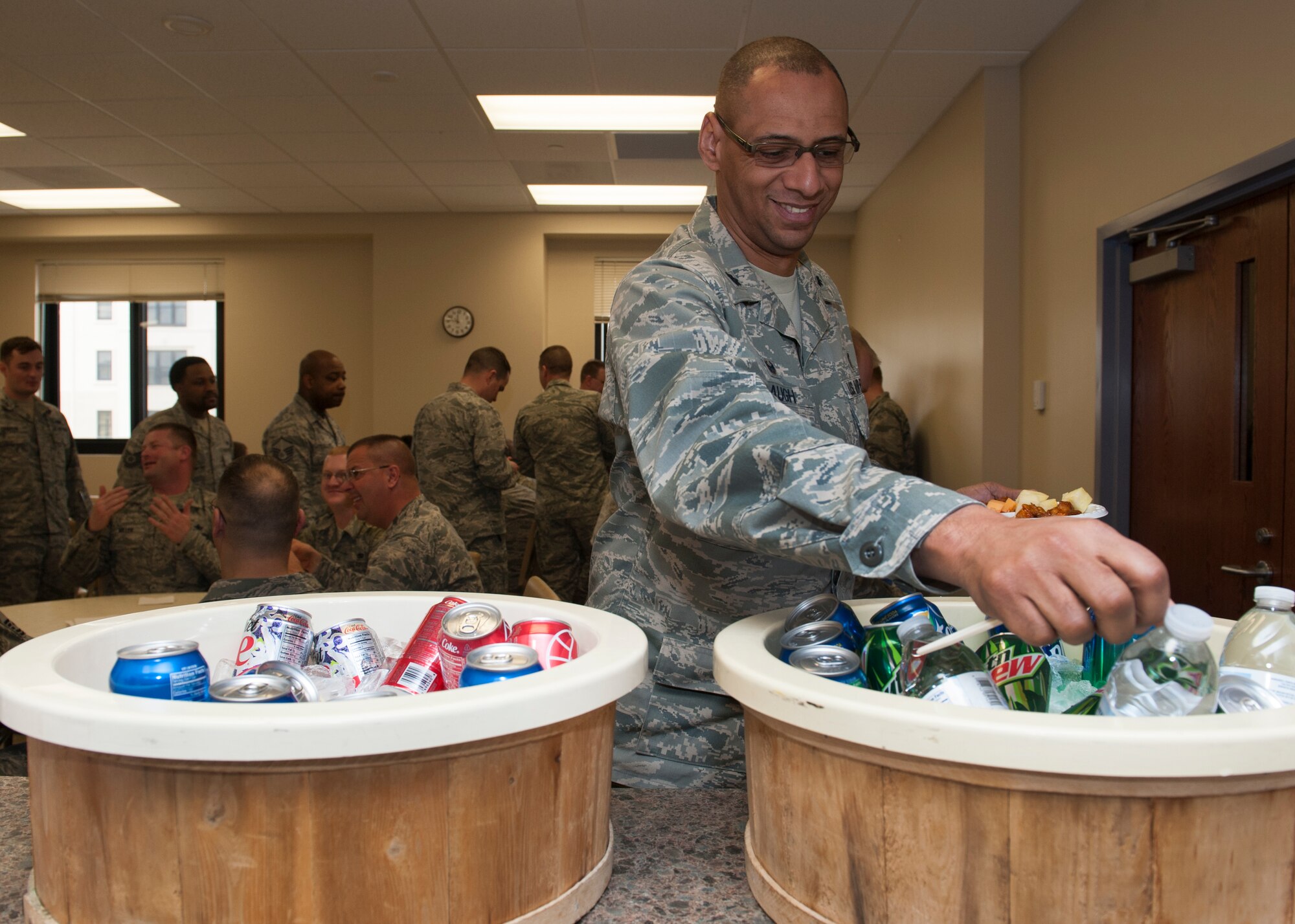 Lt. Col. Eric Baugh, 436th Dental Squadron commander, reaches for a drink at the 2016 Dover Air Force Base Air Force Assistance Fund kick off Feb. 29, 2016, at Dover AFB, Del. The AFAF lends critical support to Airmen and their families regardless of if they are active-duty or retired, officer or enlisted. Contributions enable the AFAF to assist Airmen and their families with emergency needs, educational assistance, family support and provides comfort and dignity to Air Force widows and widowers. (U.S. Air Force photo/Senior Airman Zachary Cacicia)