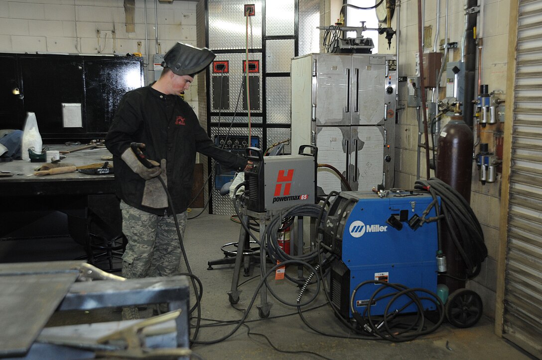 Senior Airman Garrett Bowen, 22nd Civil Engineer Squadron structural apprentice, adjusts the settings on a plasma cutter, March 3, 2016, at McConnell Air Force Base, Kan. Plasma cutting produces cleaner more accurate cuts and does not create excess metal chips as opposed to more traditional techniques. (U.S. Air Force photo/Airman Jenna K. Caldwell)  