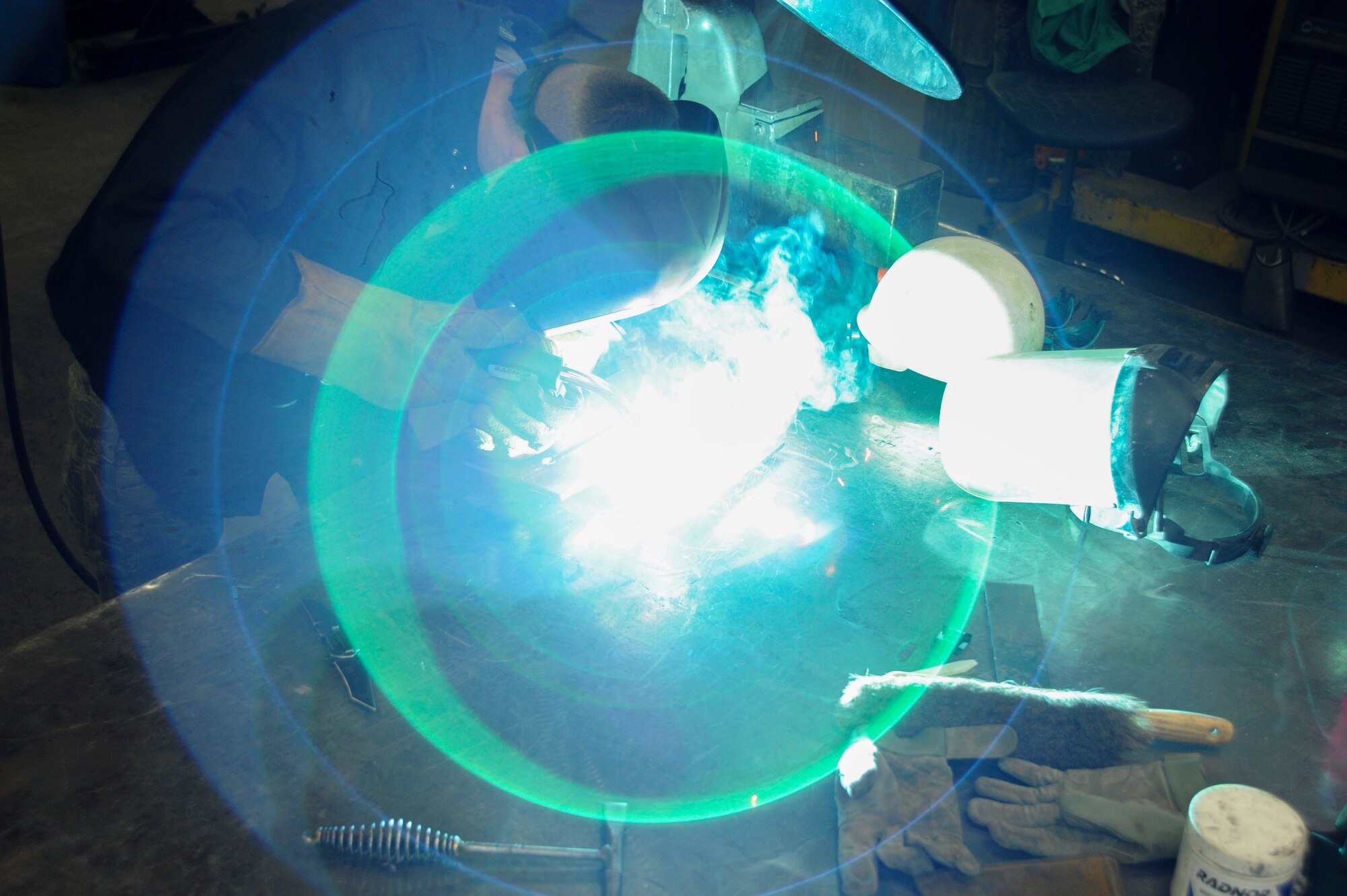 Senior Airman Garrett Bowen, 22nd Civil Engineer Squadron structural apprentice, welds a piece of metal with a metal inert gas welding process, March 3, 2016, at McConnell Air Force Base, Kan. Metal inert gas welding is used for thin metal repairs. The emitted gases are necessary to protect the welding area from atmospheric gases that can cause defects in the metal. (U.S. Air Force photo/Airman Jenna K. Caldwell)  