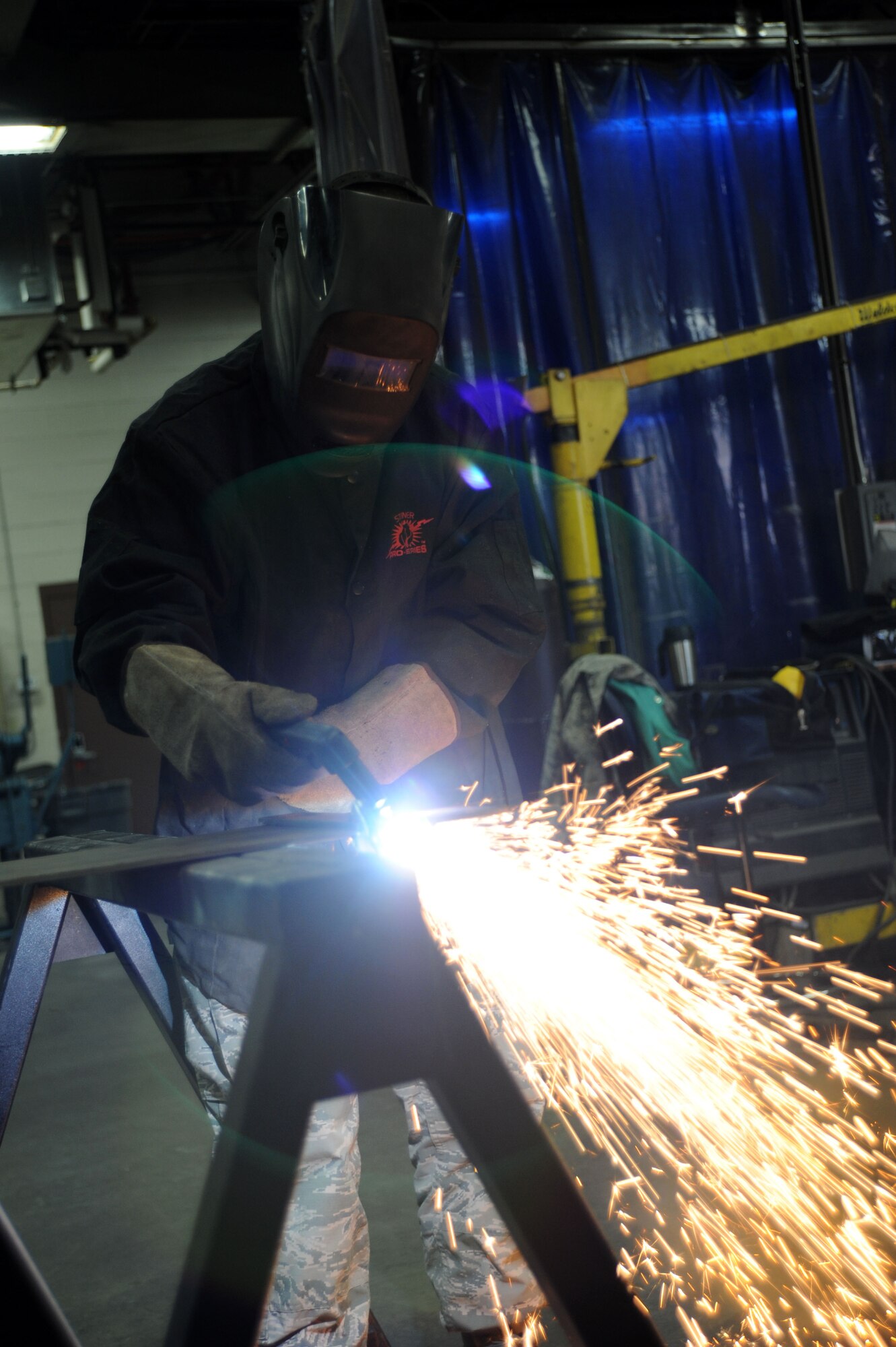 Senior Airman Garrett Bowen, 22nd Civil Engineer Squadron structural apprentice, cuts a sheet of metal with a plasma cutter, March 3, 2016, at McConnell Air Force Base, Kan. A plasma cutter cuts metal by ionizing compressed gas with an electrical arc. (U.S. Air Force photo/Airman Jenna K. Caldwell)  