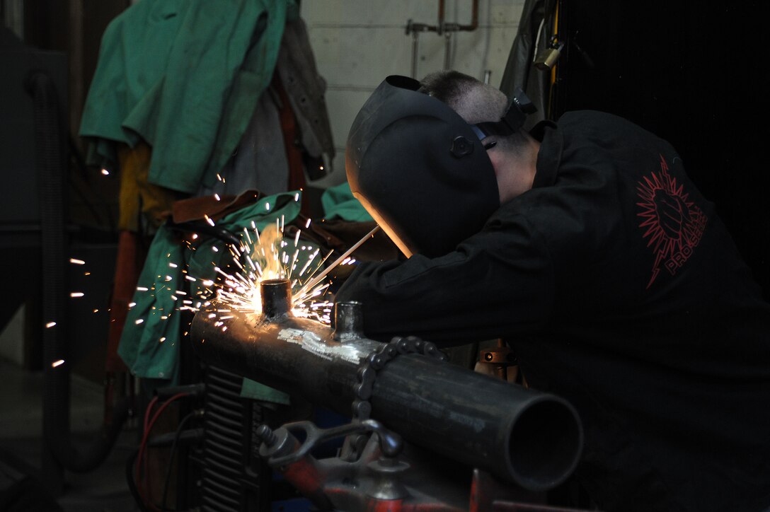 Airman 1st Class James Ori, 22nd Civil Engineer Squadron structural journeyman, welds a metal pipe with a shield metal arc welding process, March 3, 2016, at McConnell Air Force Base, Kan. Shield metal arc welding bonds metals together by forming an electric arc between the work piece and electrical conductor. (U.S. Air Force photo/Airman Jenna K. Caldwell)  