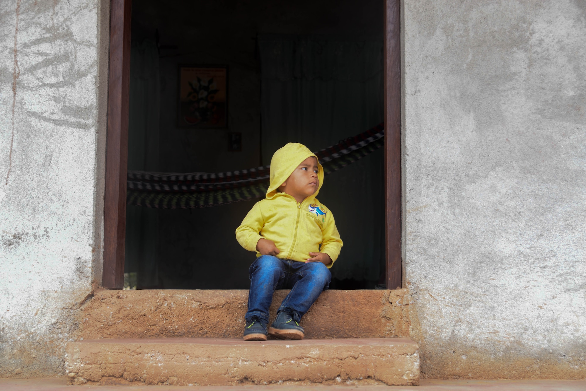A Honduran boy watches members of Joint Task Force-Bravo finish hiking to Tierra Colorada, Honduras, March 5, 2016, during Chapel Hike 66. This Chapel Hike provided 150 families with more than 3,000 pounds of donated food, assisting the villagers local leaders identified as most in need of the basic supplies. (U.S. Air Force photo by Staff Sgt. Westin Warburton/Released)