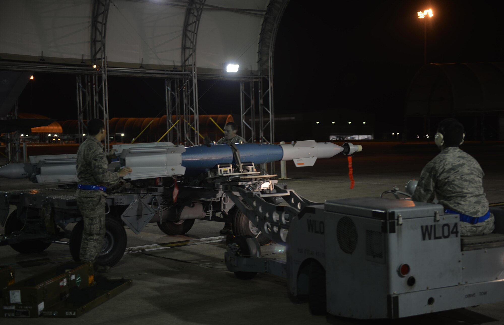 58th Aircraft Maintenance Unit weapons load crew members secure a GBU-12 to a jammer for transport to an F-35A Lightning II in the early morning March 3 at Eglin Air Force Base, Fla. This is the first time Airmen from the 33rd Fighter Wing loaded the munition into the F-35A for a weapons drop. (U.S. Air Force photo by 1st Lt. Jenny Hyden)