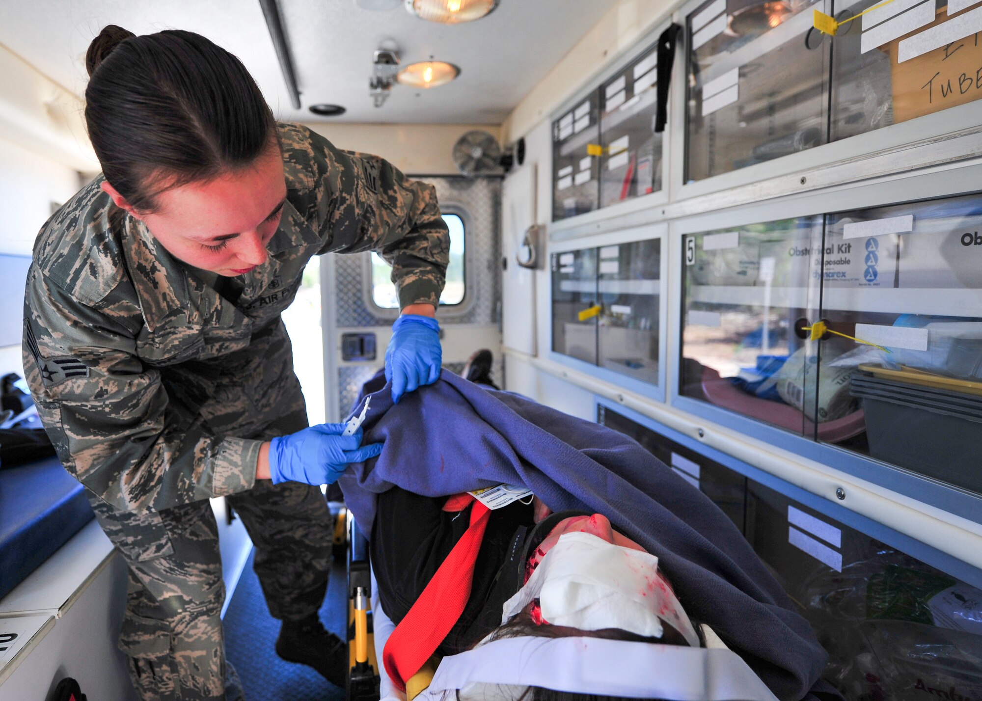 A 96th Medical Group Airman provides a blanket for one of the injured during a mass casualty exercise Feb. 25 at Eglin Air Force Base, Fla. Base medical emergency personnel, firefighters and defenders practiced rescue and safety skills during the simulated two-vehicle accident that caused 19 injuries and one death. (U.S. Air Force photo/Ilka Cole)
