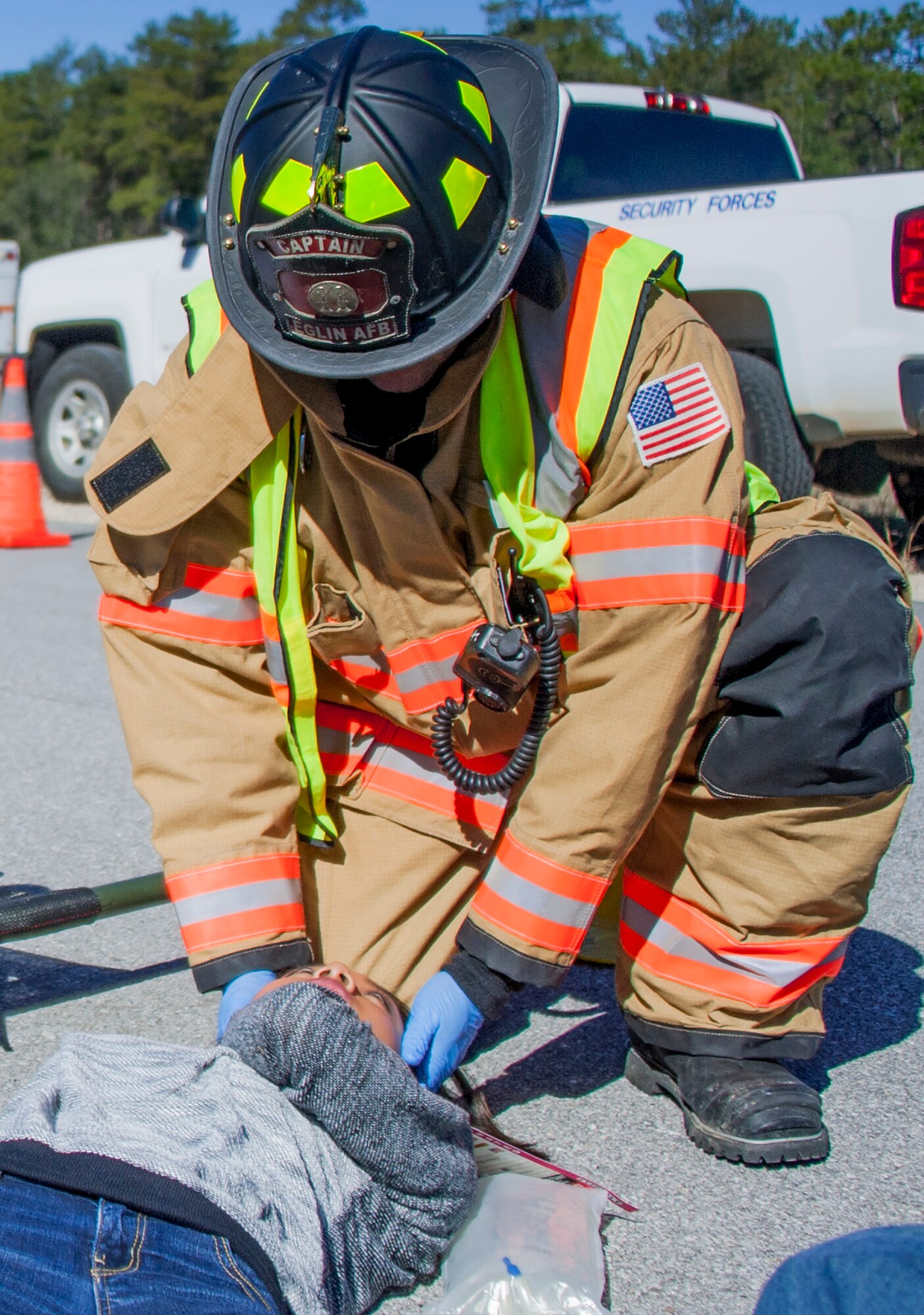 A 96th Civil Engineer Group firefighter assesses one of the injured victims during a mass casualty exercise Feb. 25 at Eglin Air Force Base, Fla. Base medical emergency personnel, firefighters and defenders practiced rescue and safety skills during the simulated two-vehicle accident that caused 19 injuries and one death. (U.S. Air Force photo/Ilka Cole)
