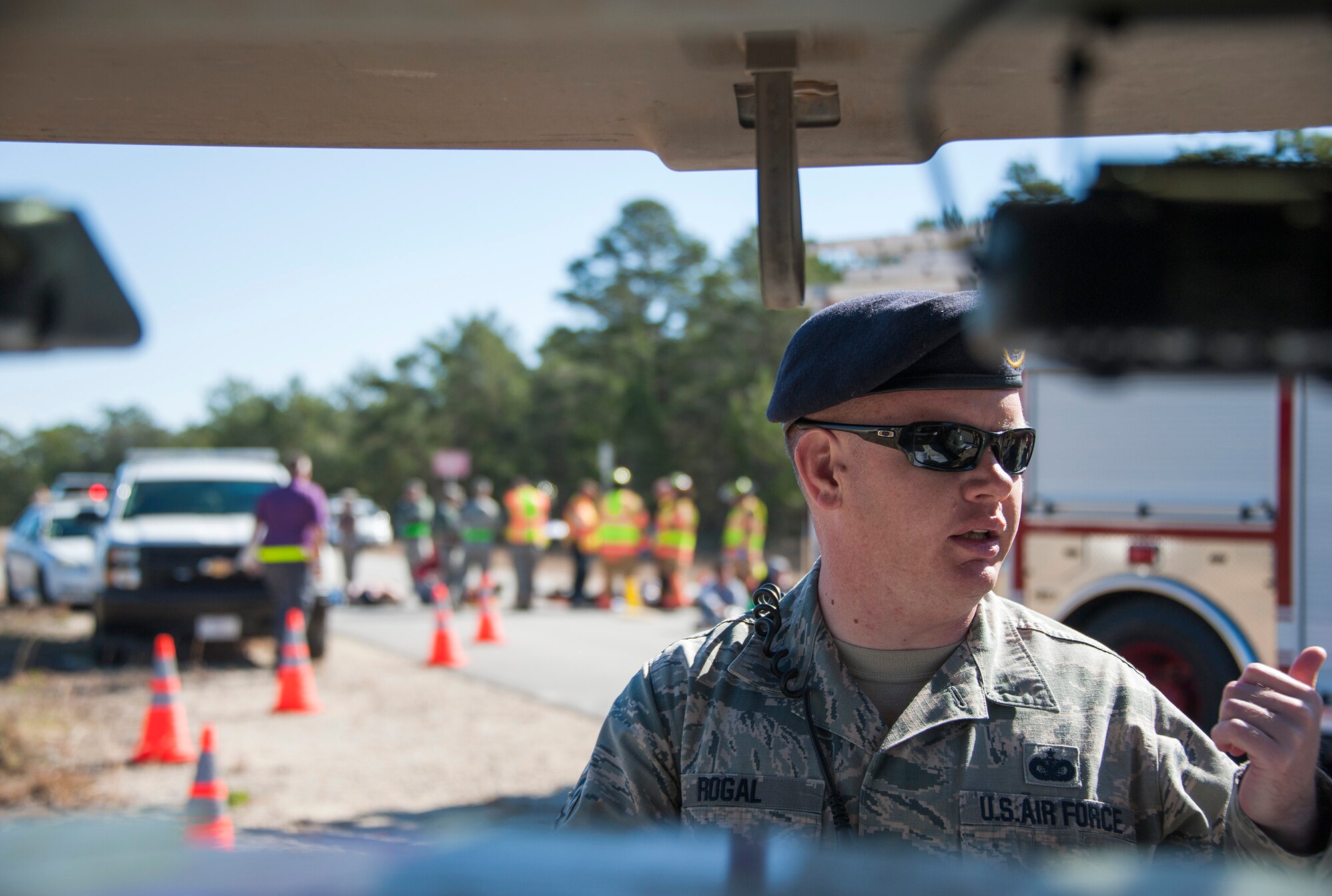 Tech. Sgt. Taylor Rogal, 96th Security Forces Squadron, coordinates with emergency personnel during a mass casualty exercise Feb. 25 at Eglin Air Force Base, Fla. Base medical emergency personnel, firefighters and defenders practiced rescue and safety skills during the simulated two-vehicle accident that caused 19 injuries and one death. (U.S. Air Force photo/Ilka Cole)