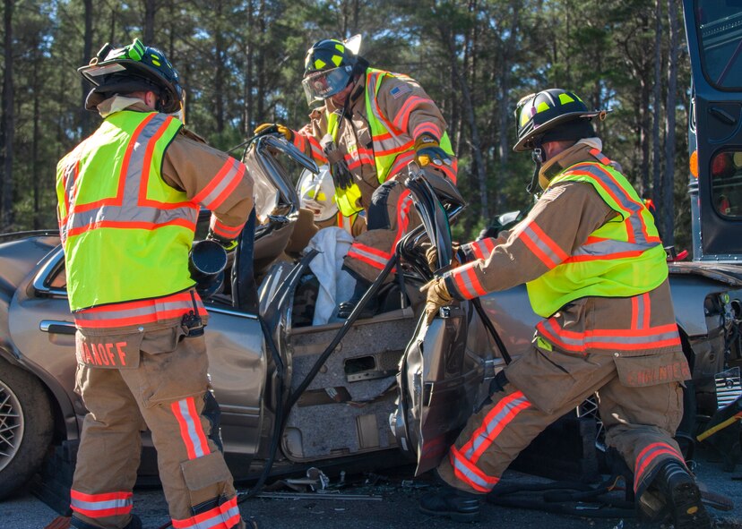 96th Civil Engineer Group firefighters extract a crash dummy from an automobile during a mass casualty exercise Feb. 25 at Eglin Air Force Base, Fla. Base medical emergency personnel, firefighters and defenders practiced rescue and safety skills during the simulated two-vehicle accident that caused 19 injuries and one death. (U.S. Air Force photo/Ilka Cole)