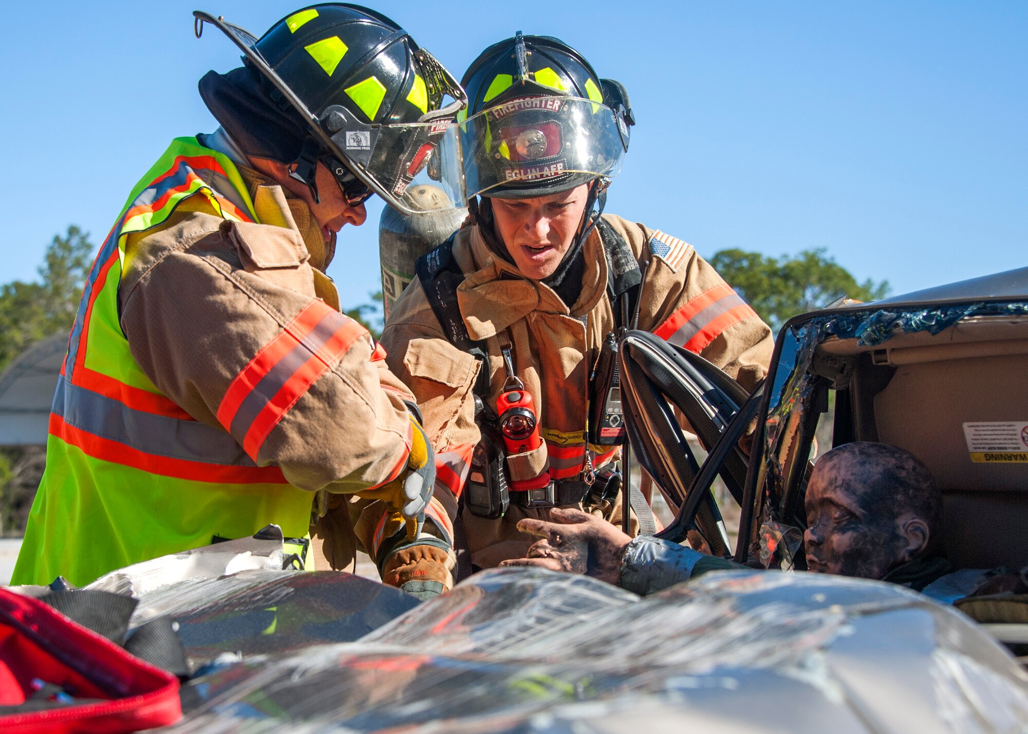 96th Civil Engineer Group firefighters extract a crash dummy from an automobile during a mass casualty exercise Feb. 25 at Eglin Air Force Base, Fla. Base medical emergency personnel, firefighters and defenders practiced rescue and safety skills during the simulated two-vehicle accident that caused 19 injuries and one death. (U.S. Air Force photo/Ilka Cole)