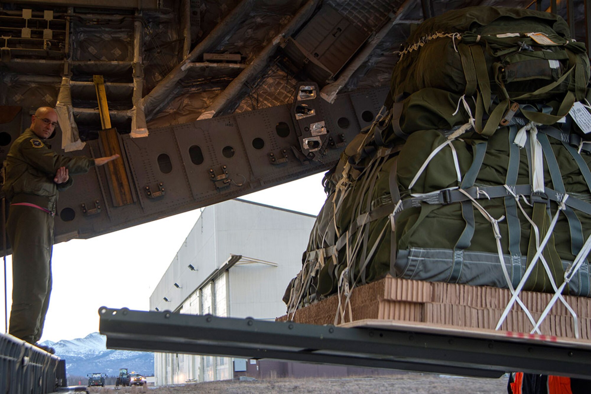 Air Force Master Sgt. Cecil Dickerson, 249th Airlift Squadron loadmaster, marshals a forklift onto the cargo ramp at Joint Base Elmendorf-Richardson, Alaska, March 2, 2016. The 249th AS is supporting the U.S. Navy Submarine Forces' Ice Exercise 2016 in the Arctic Ocean. (U.S. Air Force photo by Staff Sgt. Sheila deVera)


