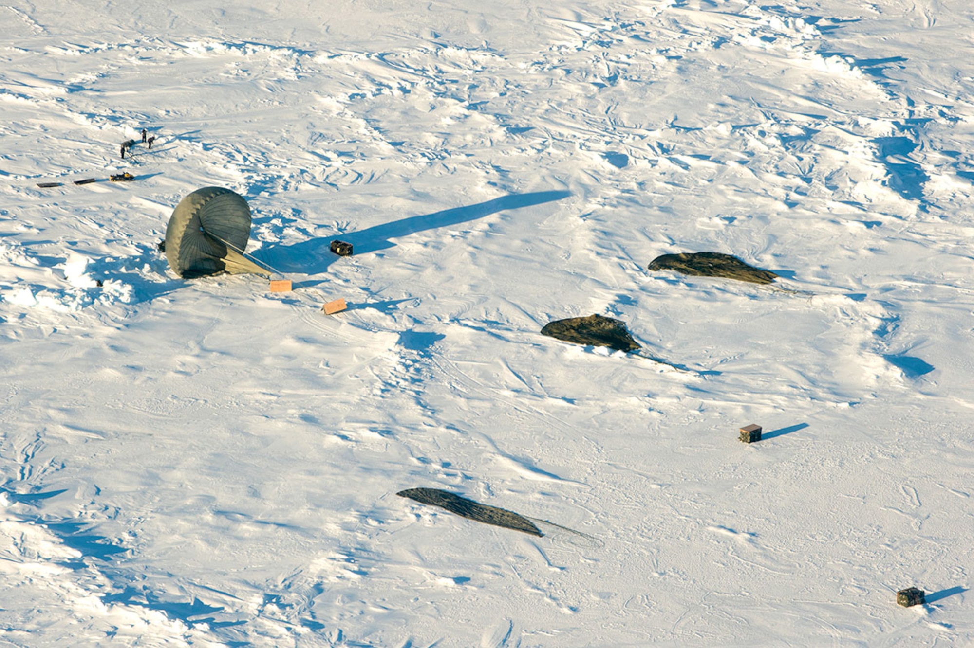 A crew from the U.S. Navy Submarine Forces retrieve several pallets cargo that were airdrop in the Arctic Ocean, March 2, 2016. (U.S. Air Force photo by Staff Sgt. Sheila deVera)


