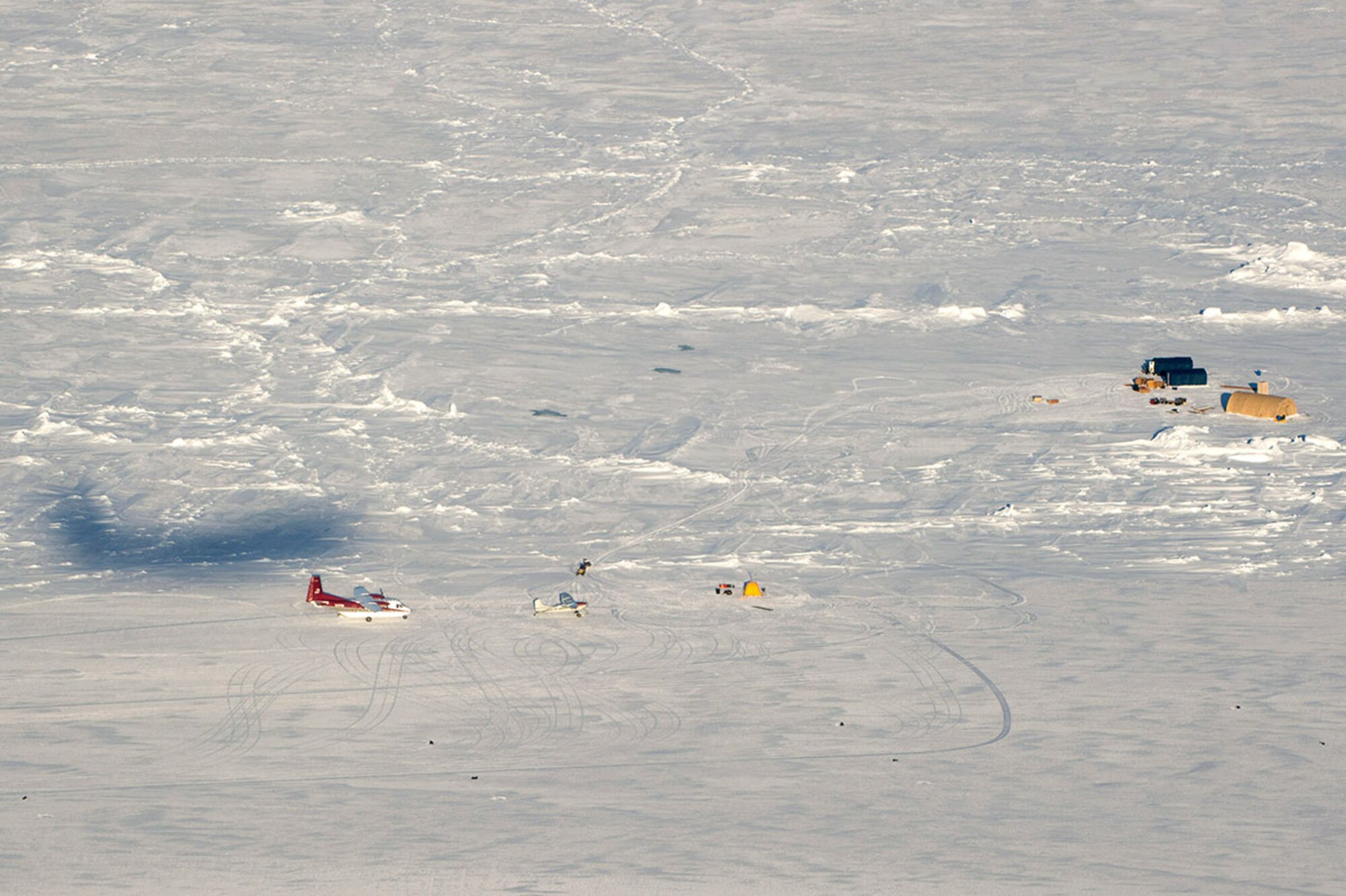 A silhouette of a C-17 Globemaster III flies over the U.S. Navy Ice Camp SARGO in the Arctic Ocean during an airdrop, March 2, 2016 in support of Ice Exercise 2016. A temporary camp is being established on a sheet of ice in the Arctic Ocean to maintain submarine readiness and support Arctic objectives and initiatives. (U.S. Air Force photo by Staff Sgt. Sheila deVera)


