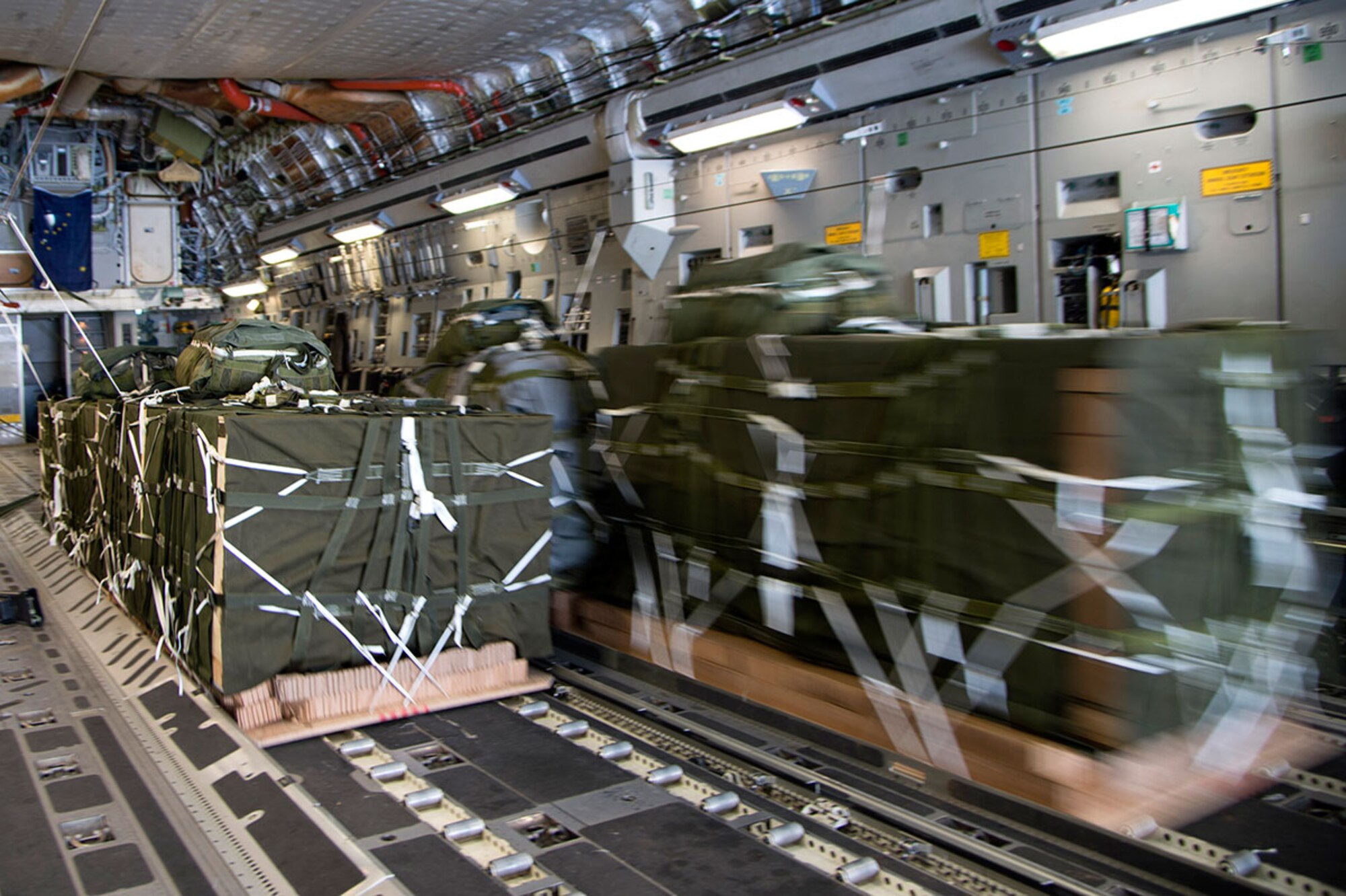 More than 12,000 pounds of cargo prepares to fall out of the back of a C-17 Globemaster III over the Arctic Ocean in support of the U.S. Navy Submarine Forces' Ice Exercise 2016.  The drop was made from 550 feet above ground level. (U.S. Air Force photo by Staff Sgt. Sheila deVera)


