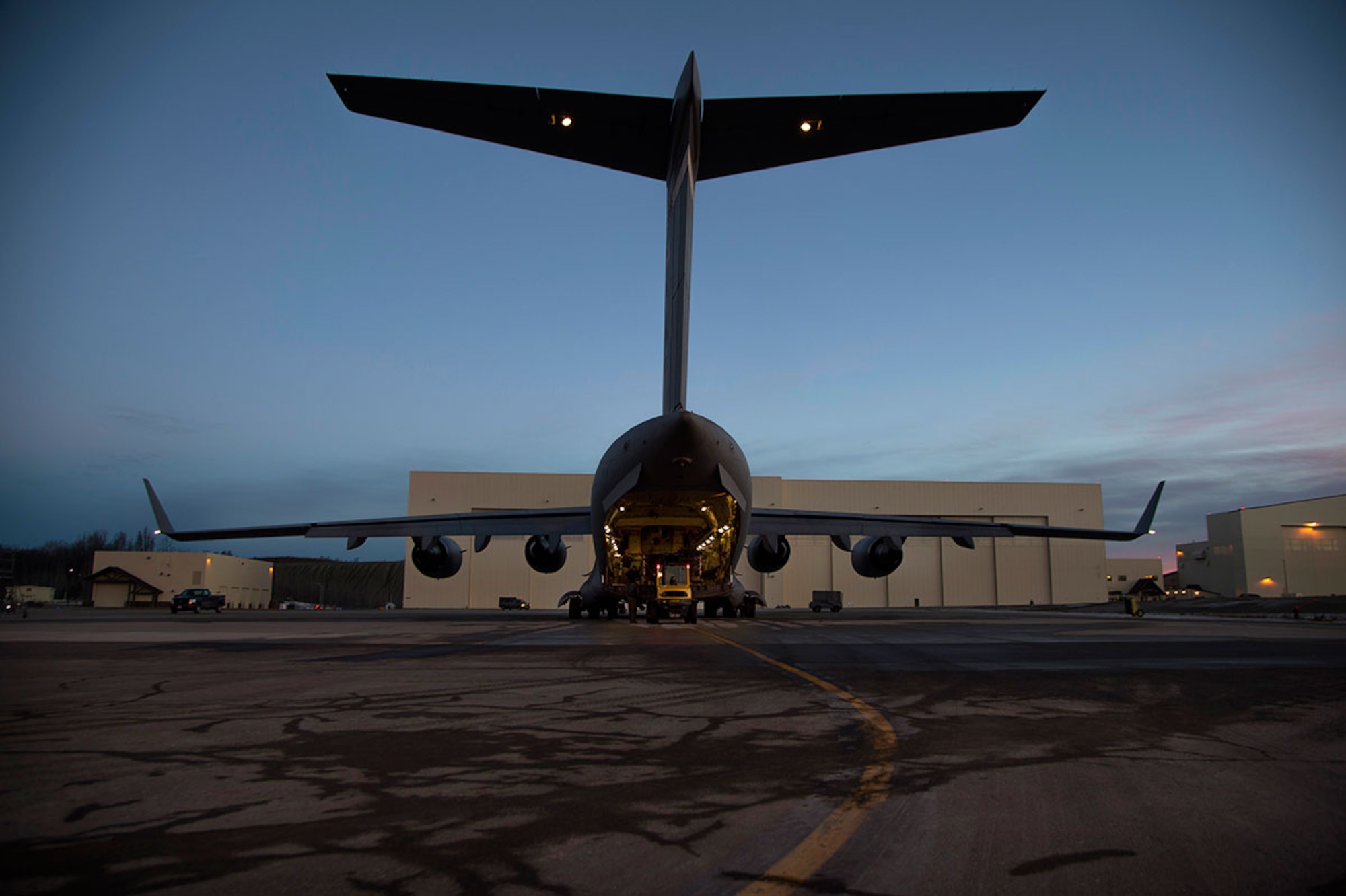 A forklift prepares to load equipment on a C-17 Globemaster III cargo ramp at Joint Base Elmendorf-Richardson, Alaska, March 2, 2016, in support of Ice Exercise 2016 in the Arctic Ocean. ICEX 2016 is a five-week exercise designed to research, test and evaluate operational capabilities in the Arctic by the U.S. Navy Submarine Forces. (U.S. Air Force photo by Staff Sgt. Sheila deVera)
