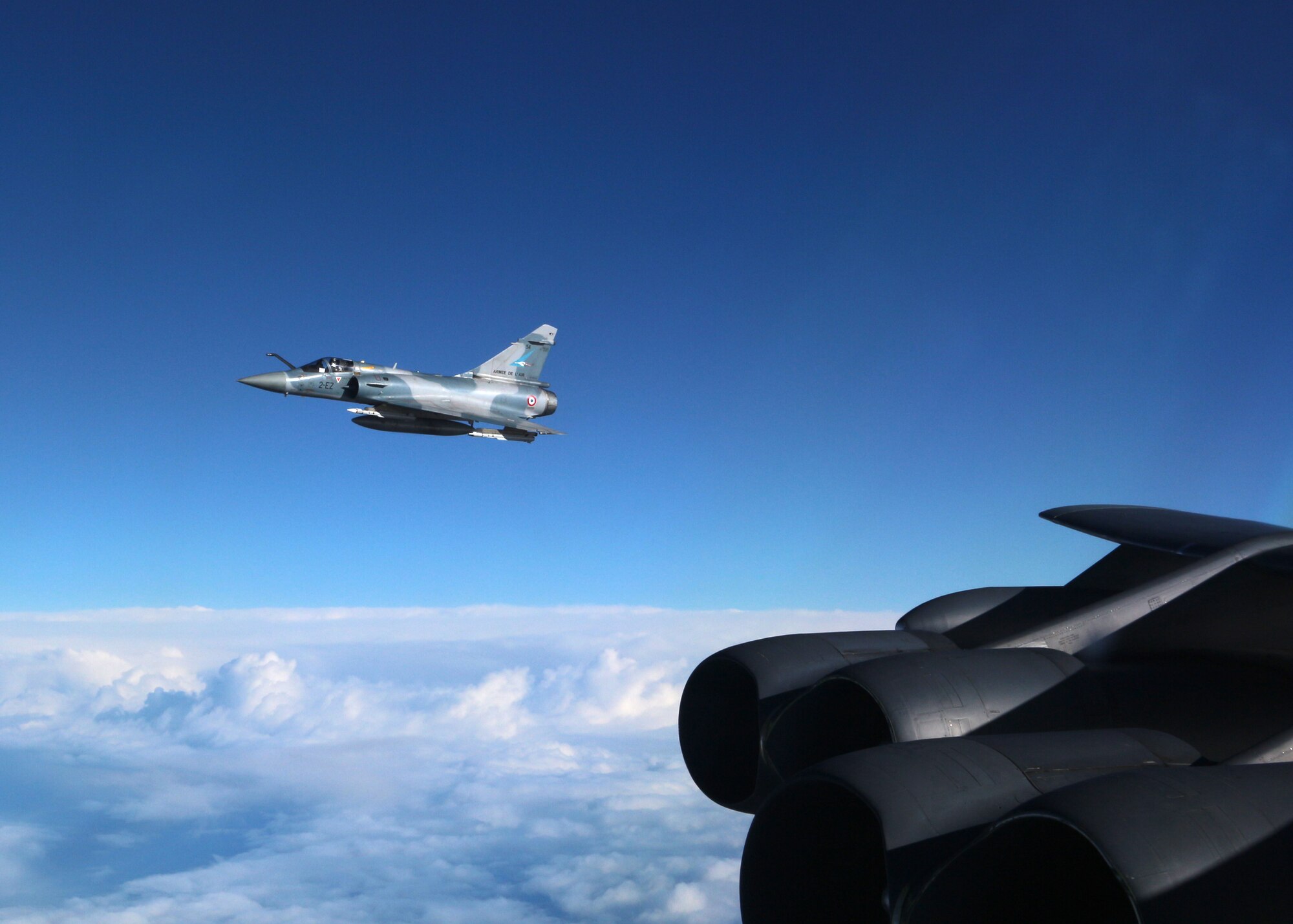 A French Mirage 2000 holds station off the wing of a U.S. Air Force B-52 Stratofortress in the skies over Northern France, March 1, 2016. Several B-52s participated in French-led close air support exercise Serpentex for the first time this year, joining forces from a dozen nations to train and develop better tactics, techniques and procedures. (U.S. Air Force courtesy photo)