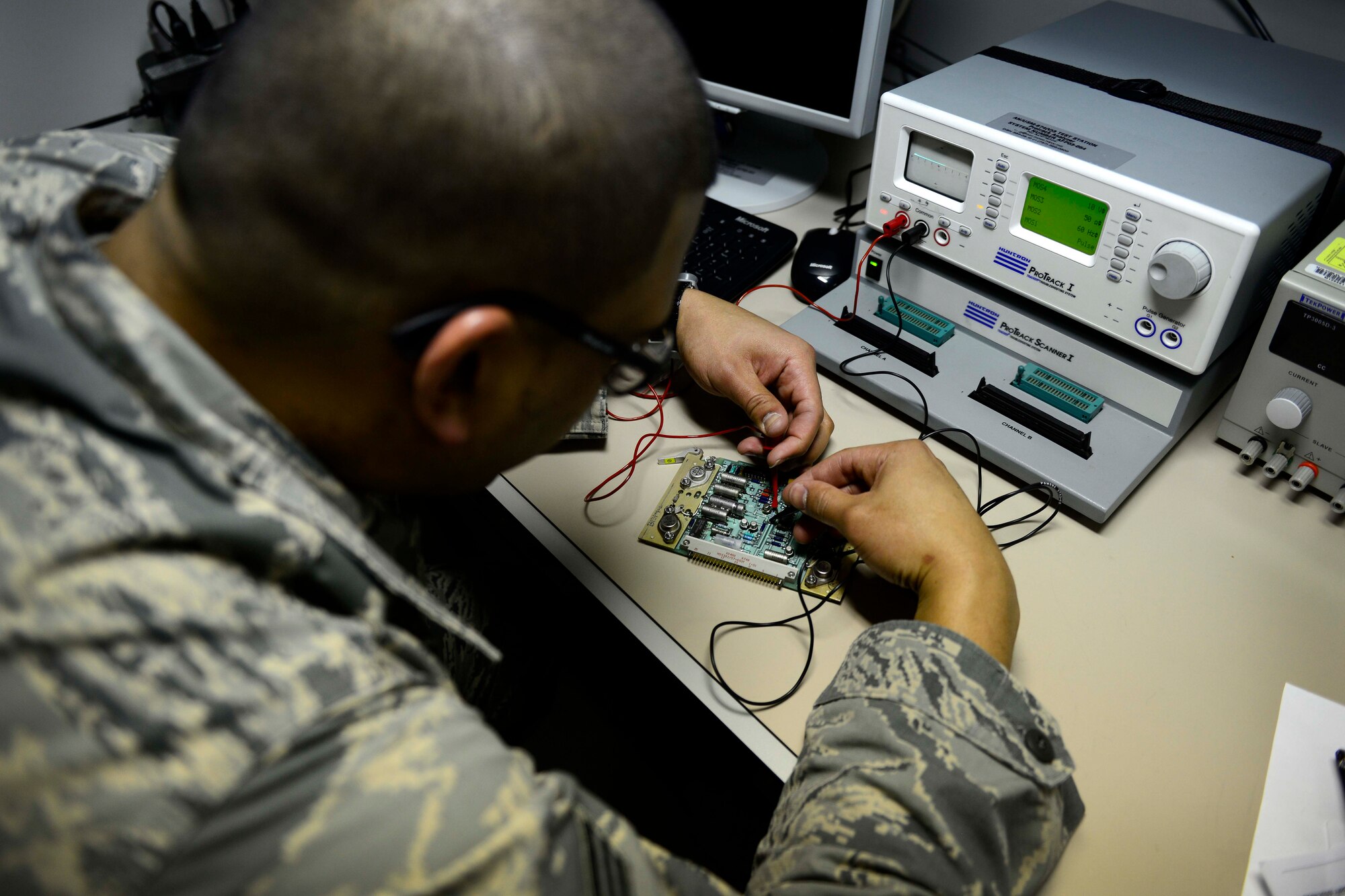 Senior Airman Edgar Diaz, 31st Maintenance Group Air Force Repair Enhancement Program technician, uses a Modular Test Repair to troubleshoot circuit card components, Feb. 25, 2016, at Aviano Air Base, Italy. Each Airman selected to fulfill this special duty position goes through an intense seven-week course where they receive Modular Test Repair, miniature and micro miniature circuit card repair training. (U.S. Air Force photo by Senior Airman Areca T. Bell/Released)