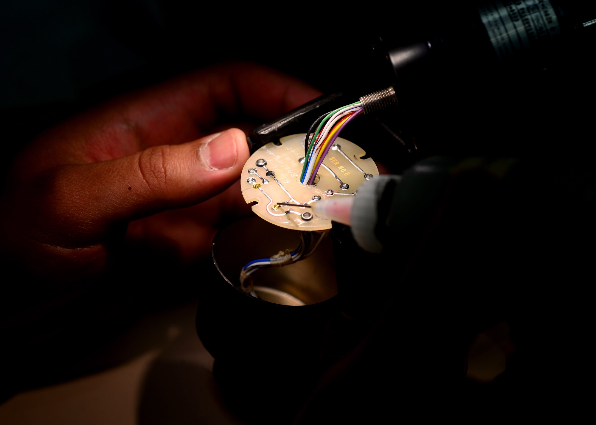 Senior Airman Edgar Diaz, 31st Maintenance Group Air Force Repair Enhancement Program technician, performs soldering repairs on circuit card components, Feb. 25, 2016, at Aviano Air Base, Italy. AFREP fixes items for free to help the base avoid spending funds that can be used for other mission needs. (U.S. Air Force photo by Senior Airman Areca T. Bell/Released)
