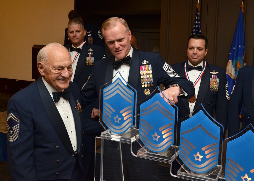 Chief Master Sergeant of the Air Force James Cody lights the chief candle with retired Chief Master Sgt. Joseph Pannitto (left) during the Space Coast Chief Master Sergeant Recognition Ceremony March 5, 2016, in Cocoa Beach, Florida. The candle symbolizes the achievement and honor of earning the highest Air Force enlisted rank. (U.S. Air Force photo by Tech. Sgt. Michael Means)