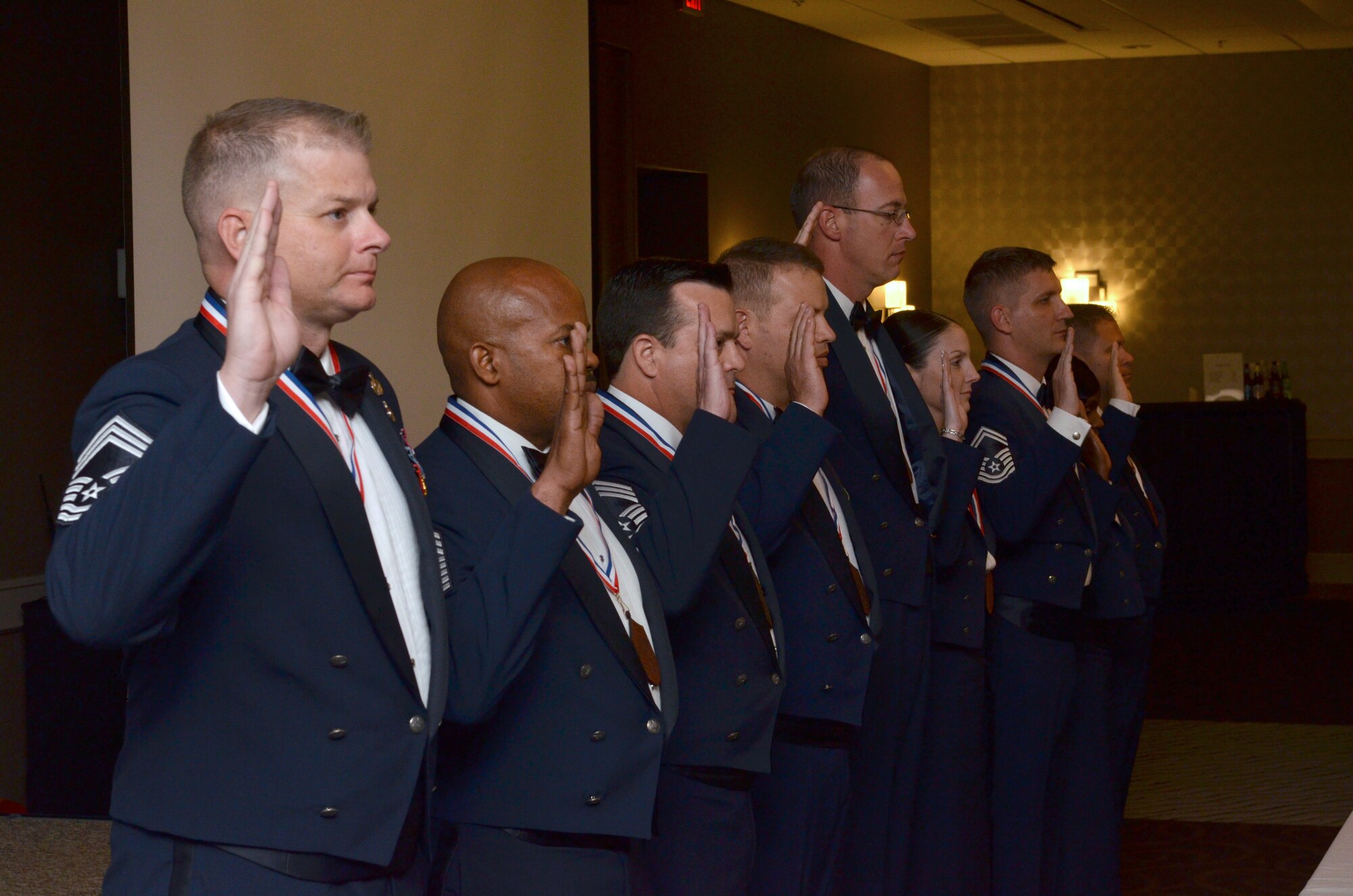 Nine new Air Force chief master sergeants and chief selects raise their right hands and repeat the Chief's Oath during the Space Coast Chief Master Sergeant Recognition Ceremony March 5, 2016, in Cocoa Beach, Florida. Approximately one percent of Airmen achieve the rank of chief, the highest enlisted rank in the Air Force. (U.S. Air Force photo by Tech. Sgt. Michael Means)
