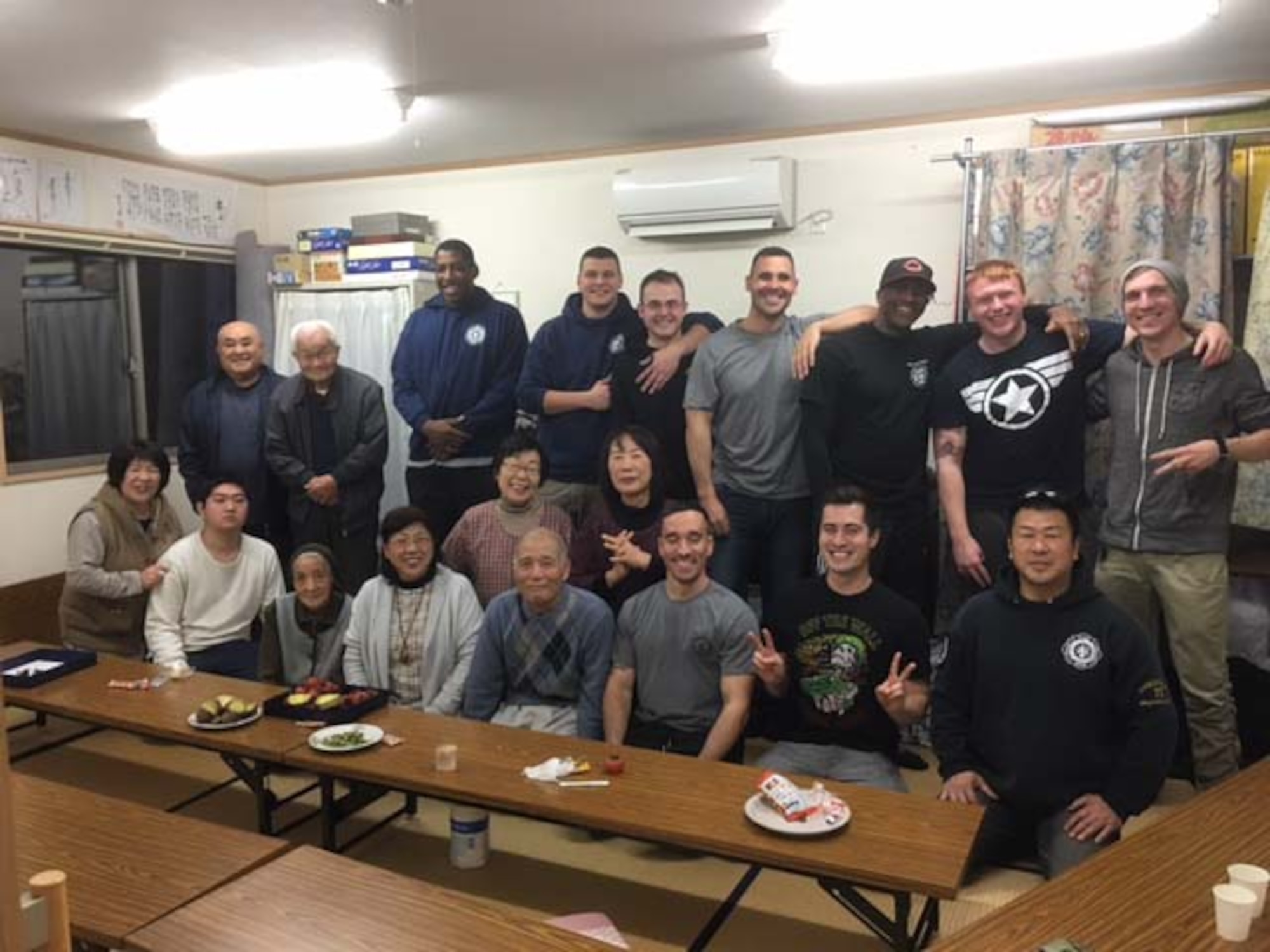 Takuya Kanto, a civilian firefighter with the 35th Civil Engineer Squadron, far right, sits with other 35th CES firefighters and citizens from Rikuzentakata Village, Japan, Dec. 22, 2015. Kanto and other 35 CES Airmen often visit villages like Rikuzentakata, areas devastated by the 2011 Great East Japan earthquake and tsunami, to provide food and assist with clean-up projects, further strengthening the relationship between the U.S. and Japan. (Courtesy Photo) 