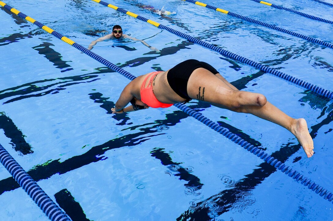 A member of the U.S. Special Operations Command's adaptive sports program team dives into a pool during an event in Tampa, Fla., March 3, 2016. Veteran and active duty special operations forces are preparing for the 2016 Department of Defense Warrior Games in June. The sports program assists with the physical and mental recovery process, and works to improve the overall health and welfare of wounded, ill or injured troops. Air Force photo by Tech. Sgt. Angelita Lawrence
