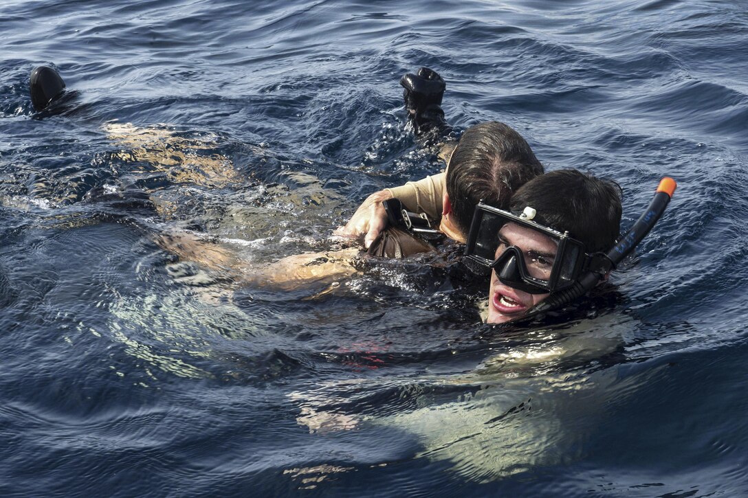 Navy Petty Officer 2nd Class Deon Farmer, right, and Navy Seaman Dylan Smith-Boccadoro conduct search-and-rescue training in the Atlantic Ocean, March 3, 2016. Farmer, a boatswain's mate, and Smith-Boccadoro, a ship's serviceman, are assigned to the USNS Spearhead. The Military Sealift Command expeditionary fast transport vessel USNS Spearhead is on a scheduled deployment to the U.S. 6th Fleet area of operations to support the international collaborative capacity-building program Africa Partnership Station. Navy photo by Petty Officer 1st Class Amanda Dunford