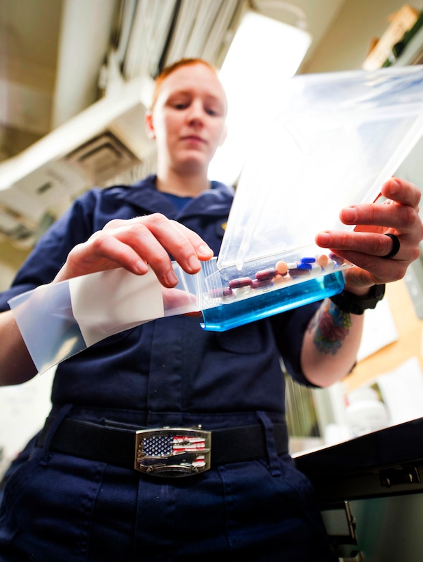 Navy Seaman Alexis Russell prepares prescriptions in the pharmacy on board the aircraft carrier USS Dwight D. Eisenhower in the Atlantic Ocean, March 2, 2016. Russell is a hospital corpsman. Navy Photo by Petty Officer 2nd Class William Jenkins