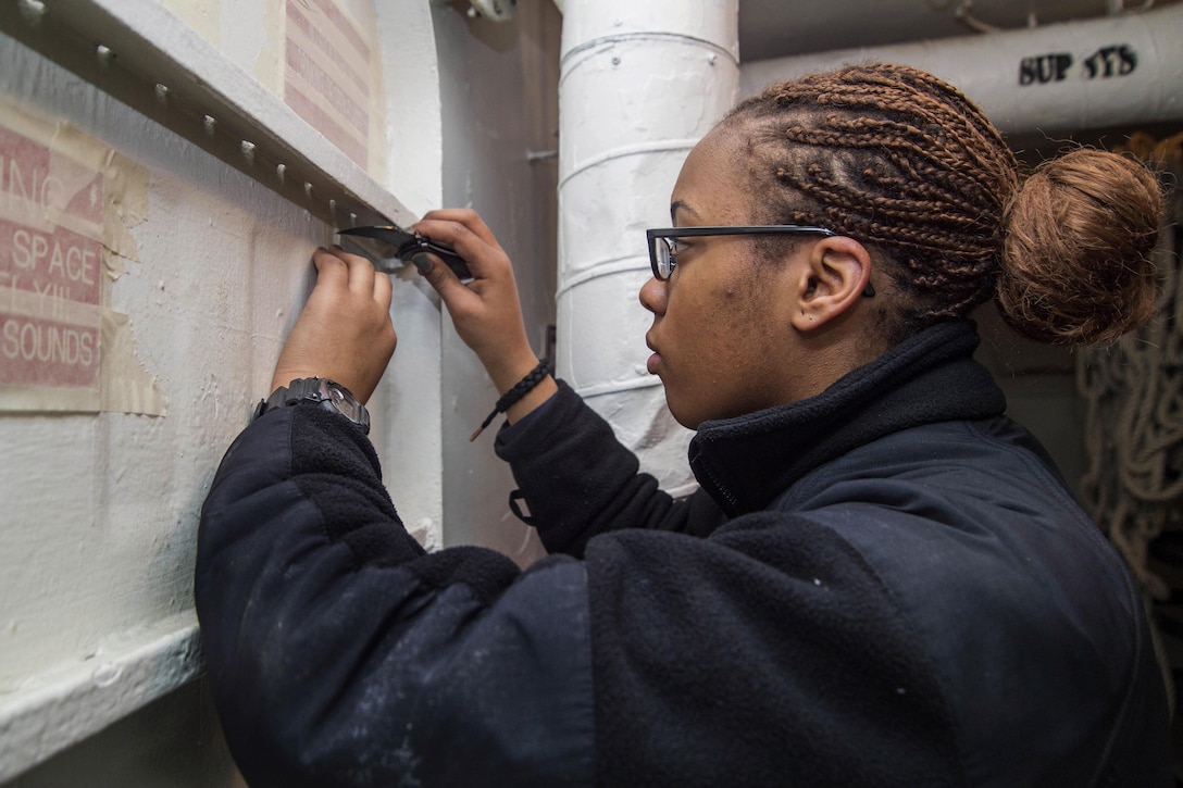 Navy Seaman Quatia Johnson prepares a hatch for painting aboard the aircraft carrier USS Dwight D. Eisenhower in the Atlantic Ocean, March 2, 2016. Navy photo by Petty Officer 3rd Class Anderson W. Branch