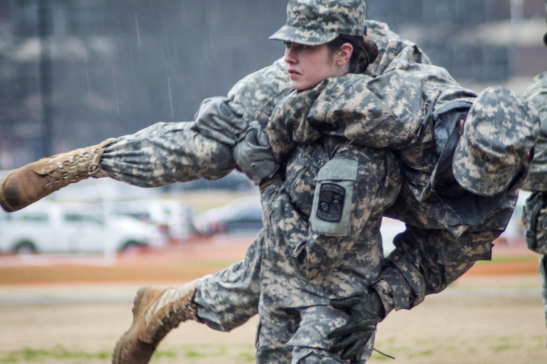 Army ROTC cadet freshman Katie Gay carries fellow cadet Katie Cook during a first aid medical training exercise at Clemson University, S.C., March 3, 2016. Army photo by Staff Sgt. Ken Scar