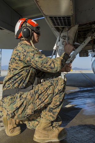 Lance Cpl. Garrett Tallent, aviation ordnance technician with Marine All-Weather Fighter Attack Squadron (VMFA) 224, installs chaff and flare buckets on an F/A-18D Hornet at Marine Corps Air Station Iwakuni, Japan, March 3, 2016. Consisting of approximately 180 Marines and 10 F/A-18D Hornet aircraft, VMFA(AW)-224 arrived in Iwakuni Oct. 7, 2015, as part of the Unit Deployment Program. VMFA(AW)-224, also known as the Fighting Bengals, will participate in exercise Island Warrior at Kaneohe Bay, Hawaii, before heading home to MCAS Beaufort, S.C. (U.S. Marine Corps photo by Lance Cpl. Aaron Henson/Released)