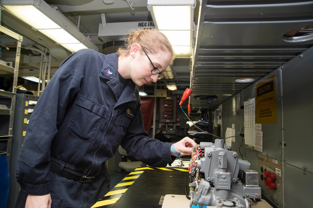 Navy Petty Officer 2nd Class Sarah Boggess inspects an induction motor in the microrepair shop of the aircraft carrier USS Dwight D. Eisenhower in the Atlantic Ocean, March 2, 2016. Boggess is an aviation electronics technician. Navy photo by Petty Officer 3rd Class Anderson W. Branch