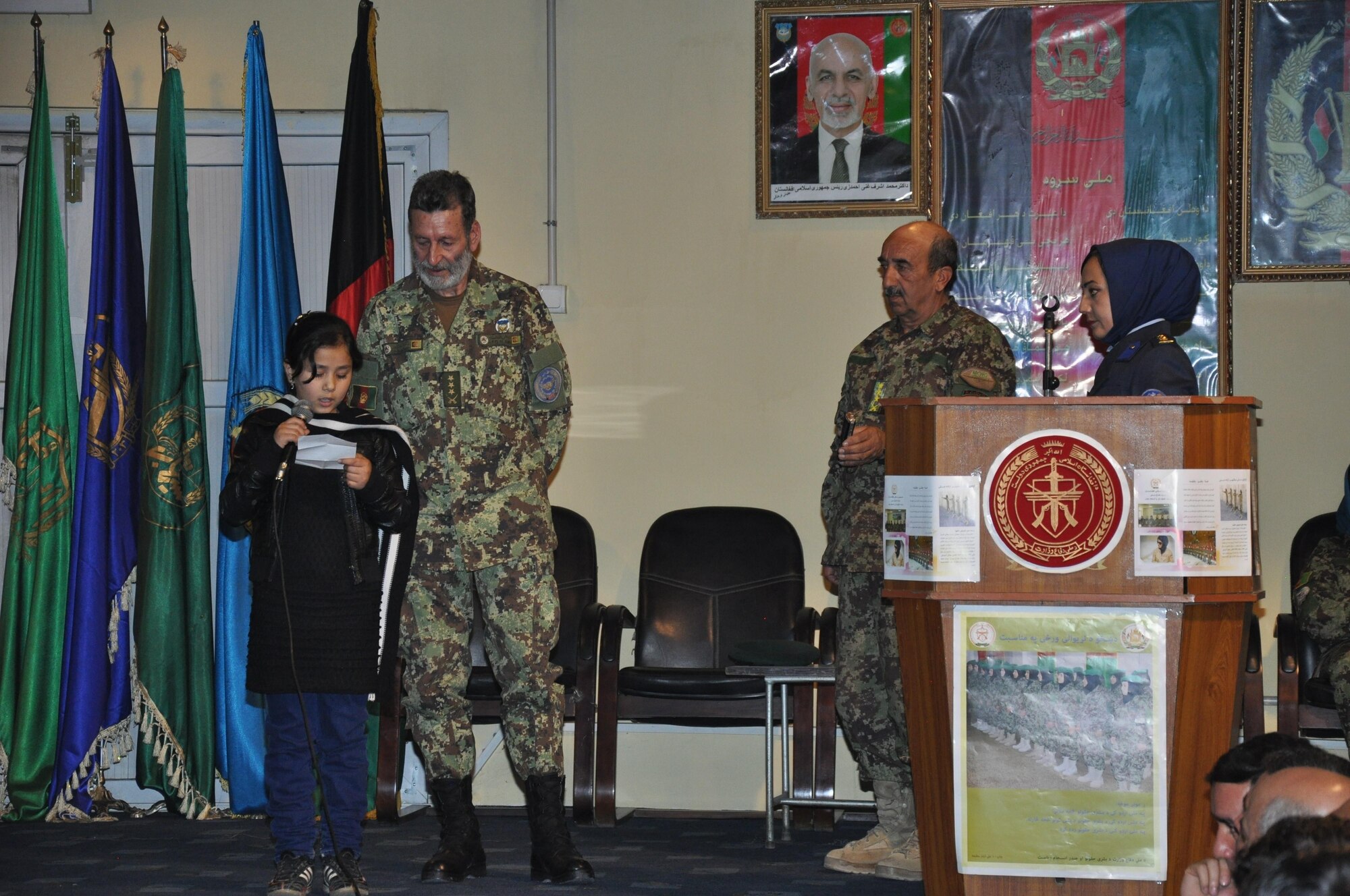 An Afghan girl reads a poem at the Afghan air force’s International Women’s Day conference March 6, 2016, at Kabul Air Wing, Kabul, Afghanistan. Approximately 200 AAF and Train, Advise, Assist Command-Air (TAAC-Air) military men and women attended the event to include guest speakers from the AAF commander to women educators and officers. (U.S. Air Force photo by Capt. Eydie Sakura/released)