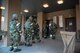 Tech. Sgt. Juan Santiago-Padin, 51st Civil Engineer Squadron airmen dorm leader, checks identification cards inside a collective protection system facility during readiness exercise Beverly Midnight 16-01 March 8, 2016, at Osan Air Base, Republic of Korea. The collective protection system facility is designed to protect personnel from biological and chemical threats. Shelter management team members ensure contamination is not brought into the facility. The exercise is designed to test Airmen's ability to survive and operate during war time conditions. (U.S. Air Force photo by Staff Sgt. Jonathan Steffen/Released) 