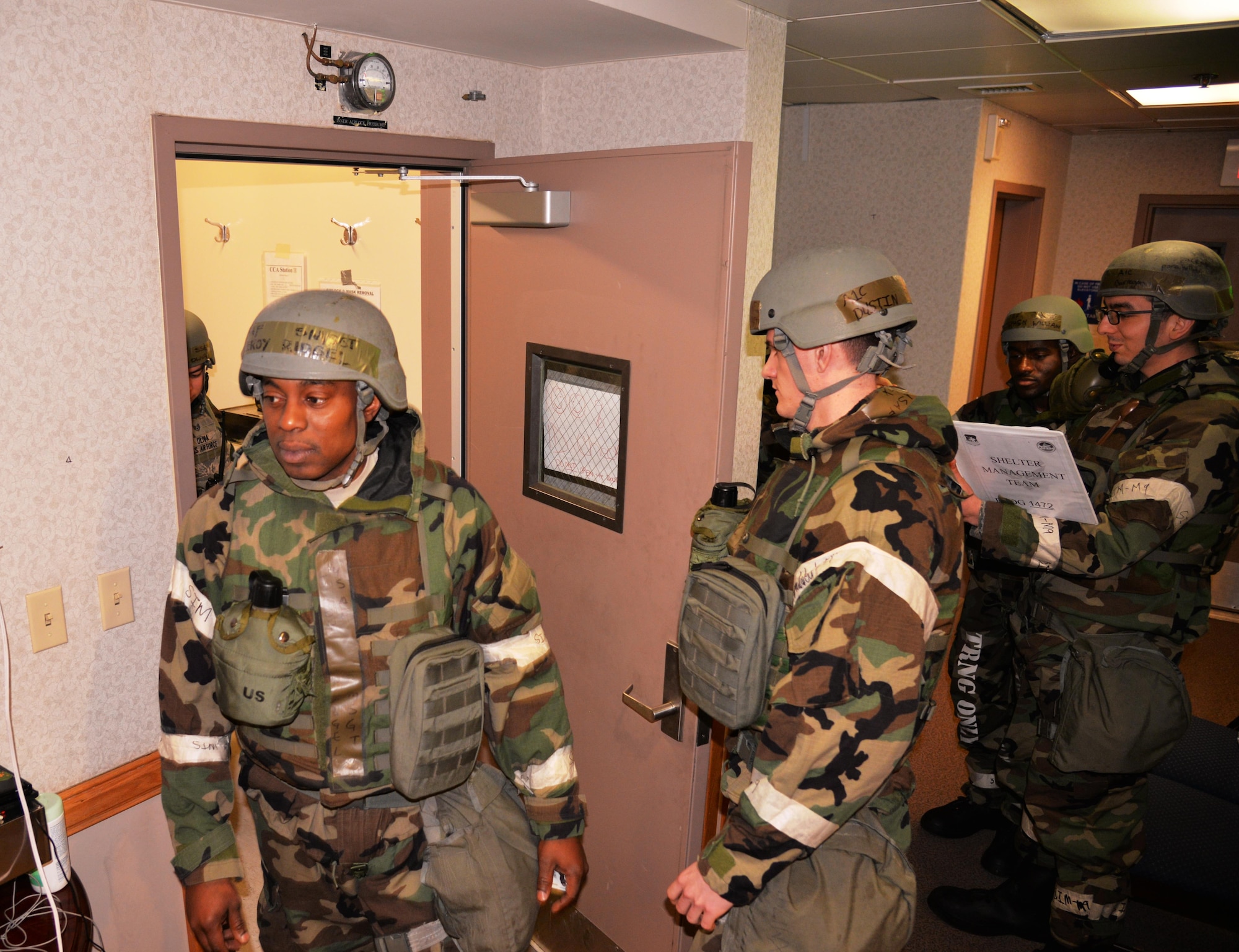 Members assigned to the 51st Fighter Wing enter a collective protection system facility March 8, 2016, at Osan Air Base, Republic of Korea. During readiness exercise Beverly Midnight 16-01, the CPS facilities provide a safe living and working area in the event of a chemical or biological threat. (U.S. Air Force photo by Staff Sgt. Benjamin Sutton/Released) 