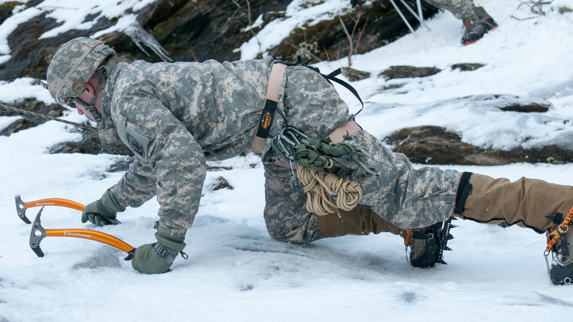 Spc. Isaac Merriam, infantry team leader, Alpha Company, 3rd Battalion, 172nd Infantry Regiment, 86th Infantry Brigade Combat Team (Mountain), Vermont National Guard, belays a fellow Soldier at Smuggler's Notch in Jeffersonville, Vt., March 5, 2016. Soldiers performed basic and advanced mountain warfare skills including ice climbing, mountain movement techniques, and nighttime navigation as part of their mountaineering winter bivouac. 