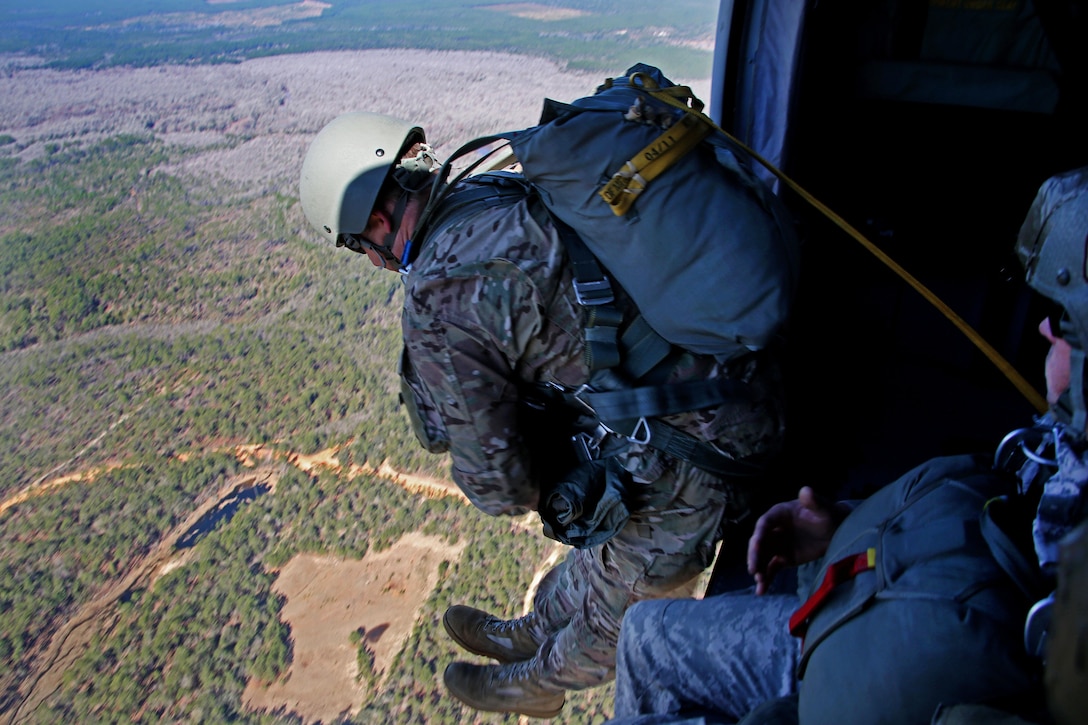 Soldiers jump out of a UH-60 Black Hawk helicopter during an airborne operation over a drop zone on Camp Rudder, Fla., Feb. 25, 2016. Army photo by Sgt. Sara Wakai