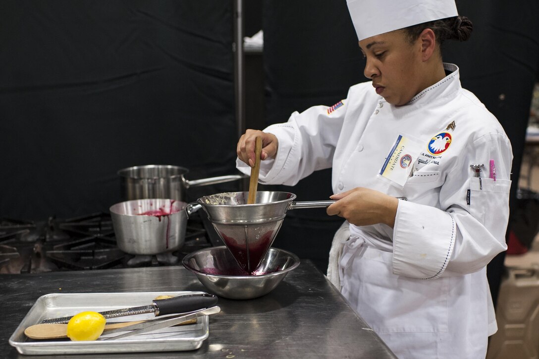 Staff Sgt. Aqueelah James, a U.S. Army Reserve Culinary Team member with the 3rd Medical Command (Deployment Support), Fort Gillem, Ga., strains a Hibiscus coulis for her Island Dream Dessert during the Practical and Contemporary Hot Food Cooking/Patisserie category at the 41st Annual Military Culinary Arts Competitive Training Event, March 7, 2016, at Fort Lee, Va. James, who earned a silver medal in the category, used the influences of her family heritage from the islands of Saint Kitts and Nevis and the Dominican Republic as inspiration for the dessert. (U.S. Army photo by Timothy L. Hale/Released)