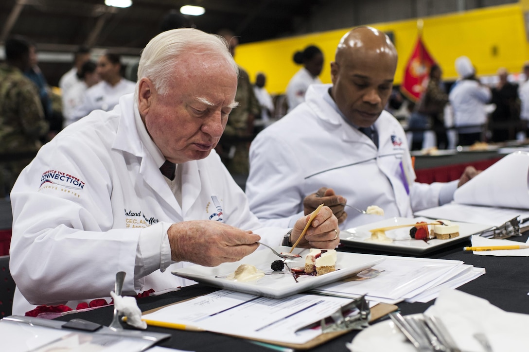 Chef judge Roland Schaeffer tastes the Island Dream Dessert entry of Staff Sgt. Aqueelah James, a U.S. Army Reserve Culinary Team member with the 3rd Medical Command (Deployment Support), Fort Gillem, Ga., in the Practical and Contemporary Hot Food Cooking/Patisserie category at the 41st Annual Military Culinary Arts Competitive Training Event, March 7, 2016, at Fort Lee, Va. James, who earned a silver medal in the category, used the influences of her family heritage from the islands of Saint Kitts and Nevis and the Dominican Republic, as inspiration for the dessert. (U.S. Army photo by Timothy L. Hale/Released)