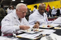 Chef judge Roland Schaeffer tastes the Island Dream Dessert entry of Staff Sgt. Aqueelah James, a U.S. Army Reserve Culinary Team member with the 3rd Medical Command (Deployment Support), Fort Gillem, Ga., in the Practical and Contemporary Hot Food Cooking/Patisserie category at the 41st Annual Military Culinary Arts Competitive Training Event, March 7, 2016, at Fort Lee, Va. James, who earned a silver medal in the category, used the influences of her family heritage from the islands of Saint Kitts and Nevis and the Dominican Republic, as inspiration for the dessert. (U.S. Army photo by Timothy L. Hale/Released)
