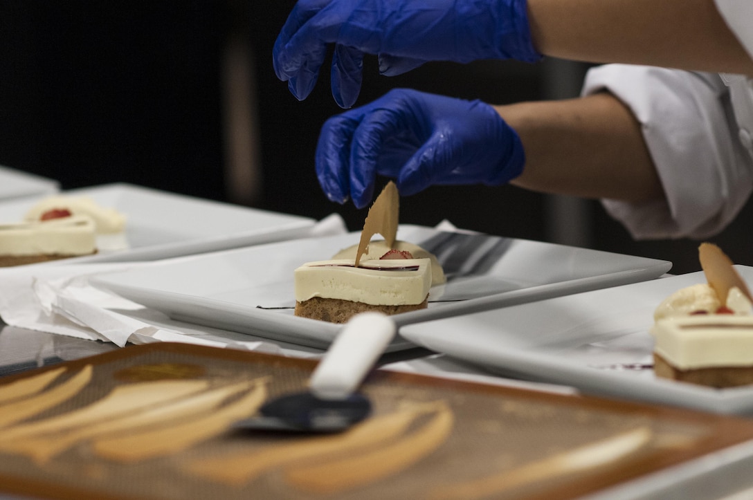 Staff Sgt. Aqueelah James, a U.S. Army Reserve Culinary Team member with the 3rd Medical Command (Deployment Support), Fort Gillem, Ga., puts the finishing touches on her Island Dream Dessert during the Practical and Contemporary Hot Food Cooking/Patisserie category at the 41st Annual Military Culinary Arts Competitive Training Event, March 7, 2016, at Fort Lee, Va. James, who earned a silver medal in the category, used the influences of her family heritage from the islands of Saint Kitts and Nevis and the Dominican Republic as inspiration for the dessert. (U.S. Army photo by Timothy L. Hale/Released)