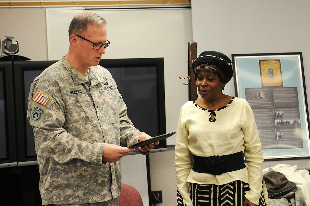 Army Reserve Brig. Gen. Frederick R. Maiocco Jr. (left), command general, 85th Support Command presents Chicago Actress Cynthia Maddox (right) with a certificate of appreciation for her performance called Five Famous African-American Women during the command’s Black History and Women’s History Month combined observance. Maddox feels that bringing history to life is more impactful than reading it from a book. (U.S. Army photo by Spc. David Lietz/Released)