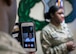 Staff Sgt. Sushil Torres addresses the audience at her reenlistment while mom Carolyn Pilgrim looks in via Apple's Facetime app at Vance Air Force Base, Oklahoma, March 1. (U.S. Air Force photo by David Poe)