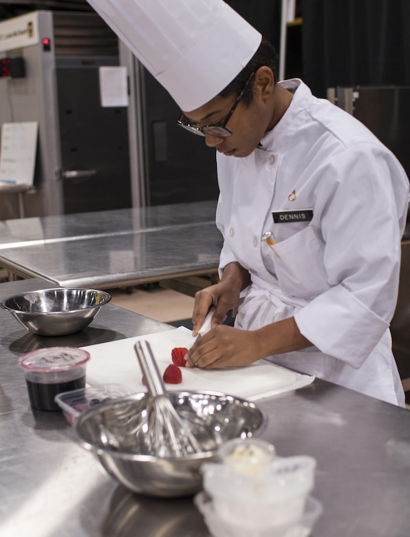 Pfc. Tyquanda Dennis, with the 275th Quartermaster Company, Fort Pickett, Va., cuts strawberries for her entry during the Armed Forces Chef of the Year competition during the 41st Annual Military Culinary Arts Competitive Training Event at the Joint Culinary Center of Excellence, March 6, 2016, at Fort Lee, Va. Dennis, who has been on the U.S. Army Reserve Culinary Arts Team for only three days, scored a bronze medal in her first competition. (U.S. Army photo by Timothy L. Hale/Released)
