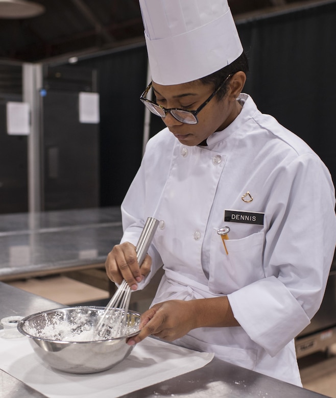 Pfc. Tyquanda Dennis, with the 275th Quartermaster Company, Fort Pickett, Va., mixes ingredients for a tuile (baked wafer) for her entry during the Armed Forces Junior Chef of the Year competition during the 41st Annual Military Culinary Arts Competitive Training Event at the Joint Culinary Center of Excellence, March 6, 2016, at Fort Lee, Va. Dennis, who has been on the U.S. Army Reserve Culinary Arts Team for only three days, scored a bronze medal in her first competition. (U.S. Army photo by Timothy L. Hale/Released)