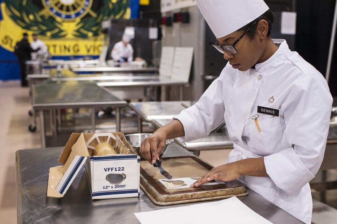 Pfc. Tyquanda Dennis, with the 275th Quartermaster Company, Fort Pickett, Va., applies tuile (baked wafer) to a baking sheet for her entry during the Armed Forces Junior Chef of the Year competition during the 41st Annual Military Culinary Arts Competitive Training Event at the Joint Culinary Center of Excellence, March 6, 2016, at Fort Lee, Va. Dennis, who has been on the U.S. Army Reserve Culinary Arts Team for only three days, scored a bronze medal in her first competition. (U.S. Army photo by Timothy L. Hale/Released)