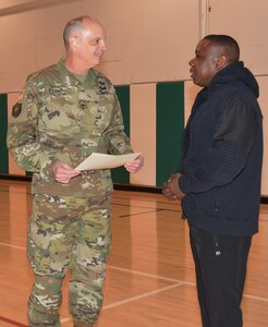 Brig. Gen. Thomas P. Evans, deputy commander 80th Training Command presents a certificate of appreciation to David Durham for his efforts during the command’s health and fitness training event for individuals with body weight and Army Physical Fitness Test challenges. Durham conducted a full body boot camp on day two of the three day event at the command headquarters, Richmond, Va., March 5, 2016.