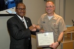 Retired Vice Adm. Melvin Williams Jr. receives a certificate of appreciation from Naval Surface Warfare Center, Carderock Division Commanding Officer Capt. Rich Blank for speaking at the command's Martin Luther King Jr. Day/African American History Month observance in West Bethesda, Md., Feb. 3, 2016. (U.S. Navy photo by Harry Friedman/Released)