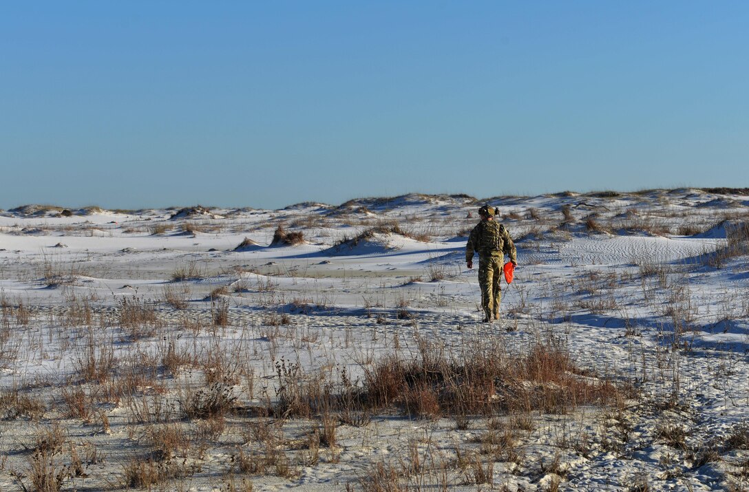 An Army Ranger from the 75th Ranger Regiment, 3rd Ranger Battalion, signals an aircraft to his team’s position at Hurlburt Field, Fla., Feb. 11, 2016. During this exercise, Rangers radioed coordinates to F-35A Lightning II pilots to simulate close air support. (U.S. Air Force photo/Senior Airman Andrea Posey)