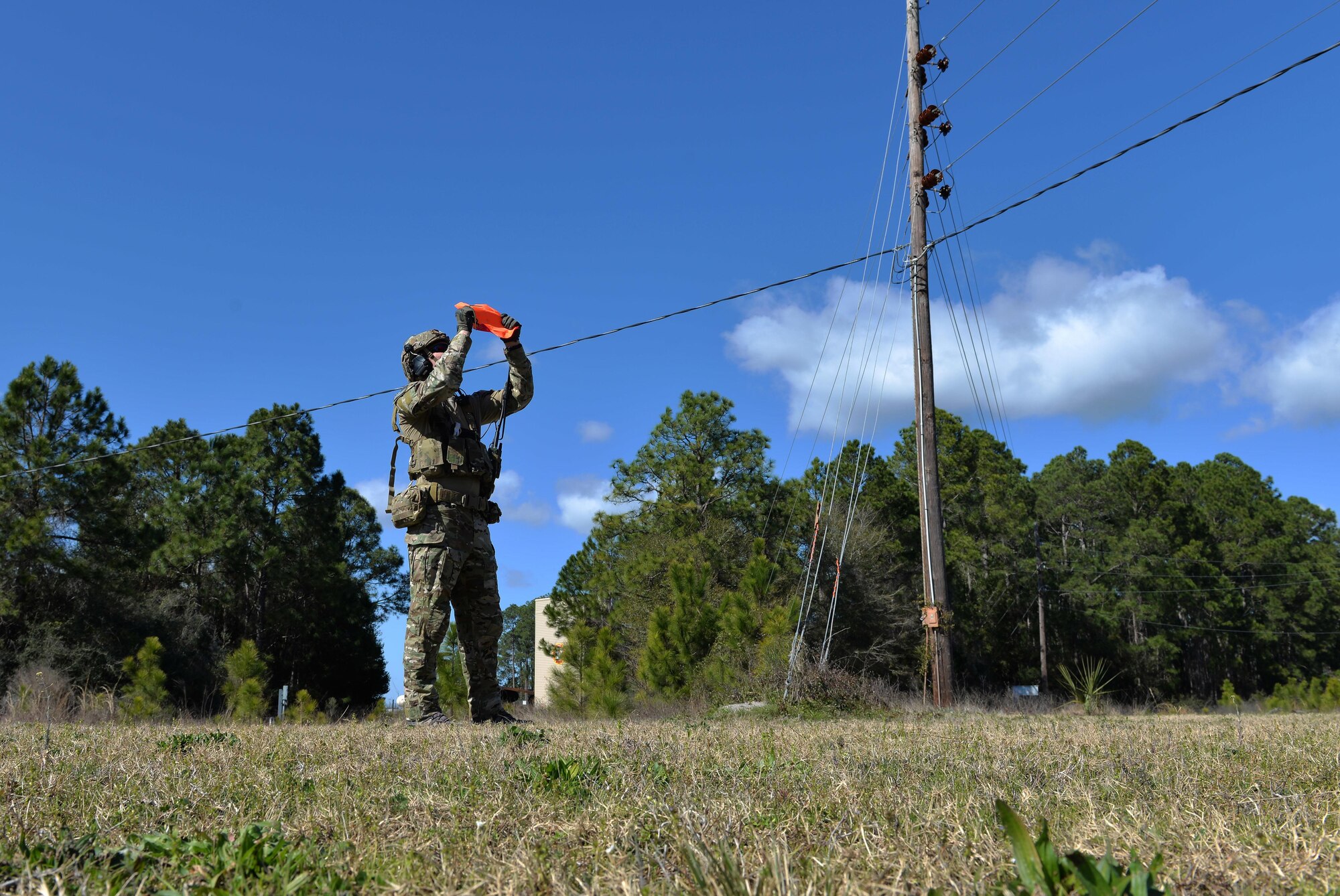 An Army Ranger from the 75th Ranger Regiment, 3rd Ranger Battalion, signals an aircraft to his team’s position at Hurlburt Field, Fla., Feb. 11, 2016. During this exercise, Rangers radioed coordinates to F-35A Lightning II pilots to simulate close air support. (U.S. Air Force photo/Senior Airman Andrea Posey)